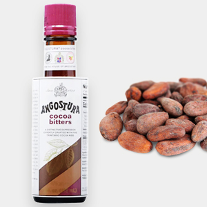 A bottle of Angostura cocoa bitters stands next to a small pile of fine flavour cocoa beans on a light background. | Trinitario