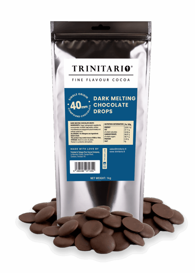 A silver 1kg bag of Dark Chocolate Melting Drops stands upright, surrounded by chocolate drops, displaying its blue label—crafted from fine flavour Caribbean cocoa for an authentic single-origin chocolate experience. | Trinitario