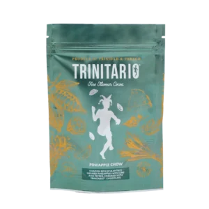A green Trinitario chocolate pouch labelled "Pineapple Chow" features gold Caribbean cocoa pod illustrations and a central white figure. The text highlights it as a single-origin chocolate product of Trinidad & Tobago. | Trinitario