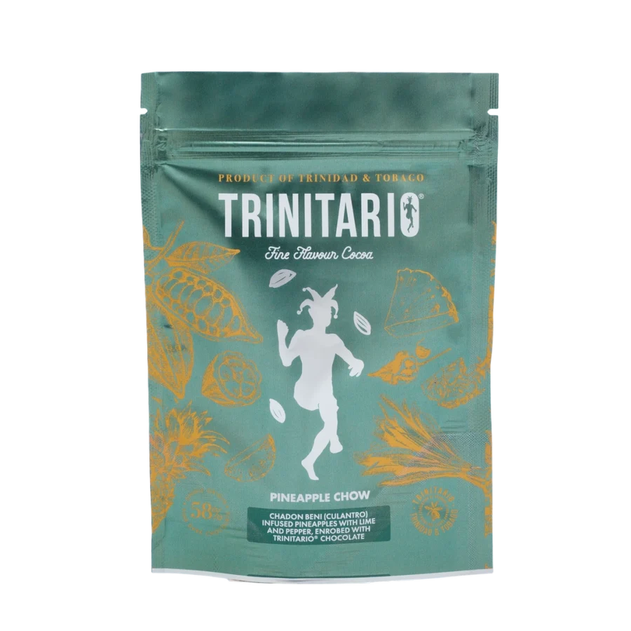 A green Trinitario chocolate pouch labelled "Pineapple Chow" features gold Caribbean cocoa pod illustrations and a central white figure. The text highlights it as a single-origin chocolate product of Trinidad & Tobago. | Trinitario