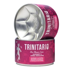 A cylindrical tin of Trinitario chocolate raspberry and sorrel medallions, crafted from fine flavour cocoa, partially opened to reveal the medallion-shaped interior. | Trinitario