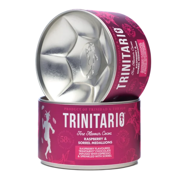 A cylindrical tin of Trinitario chocolate raspberry and sorrel medallions, crafted from fine flavour cocoa, partially opened to reveal the medallion-shaped interior. | Trinitario