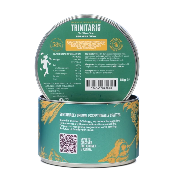 A round tin of Trinitario Pineapple Chow dark chocolate made with Caribbean cocoa, with the lid showing nutritional information, ingredients, and a QR code; the side highlights sustainably grown chocolate and features gold graphics. | Trinitario