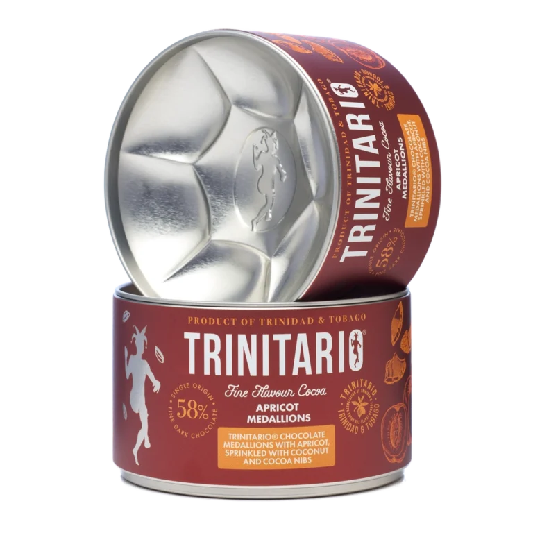 Round tin of handcrafted Trinitario chocolate apricot medallions, labelled as 58% dark chocolate with apricot, coconut, and cocoa nibs. Product of Trinidad & Tobago. One tin is open and tilted on another. | Trinitario