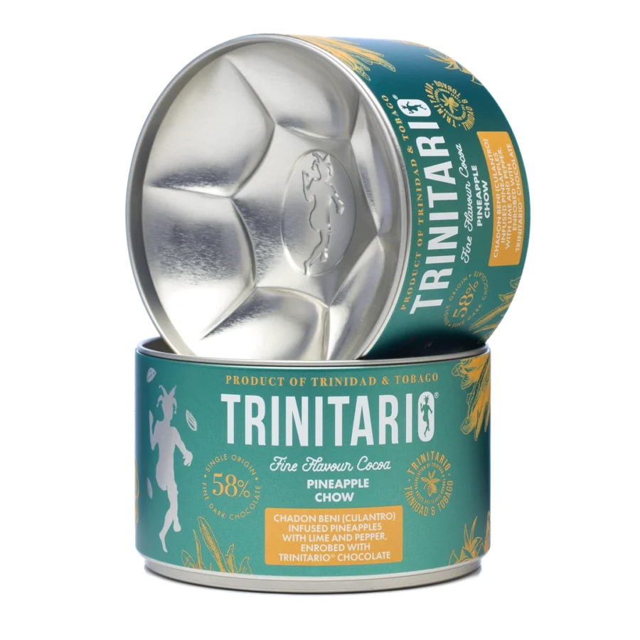 A tin of Trinitario Fine Flavour Cocoa Pineapple Chow with the lid partially open, showcasing its branding and label details. Made with sustainably grown chocolate for a rich and flavourful experience. | Trinitario
