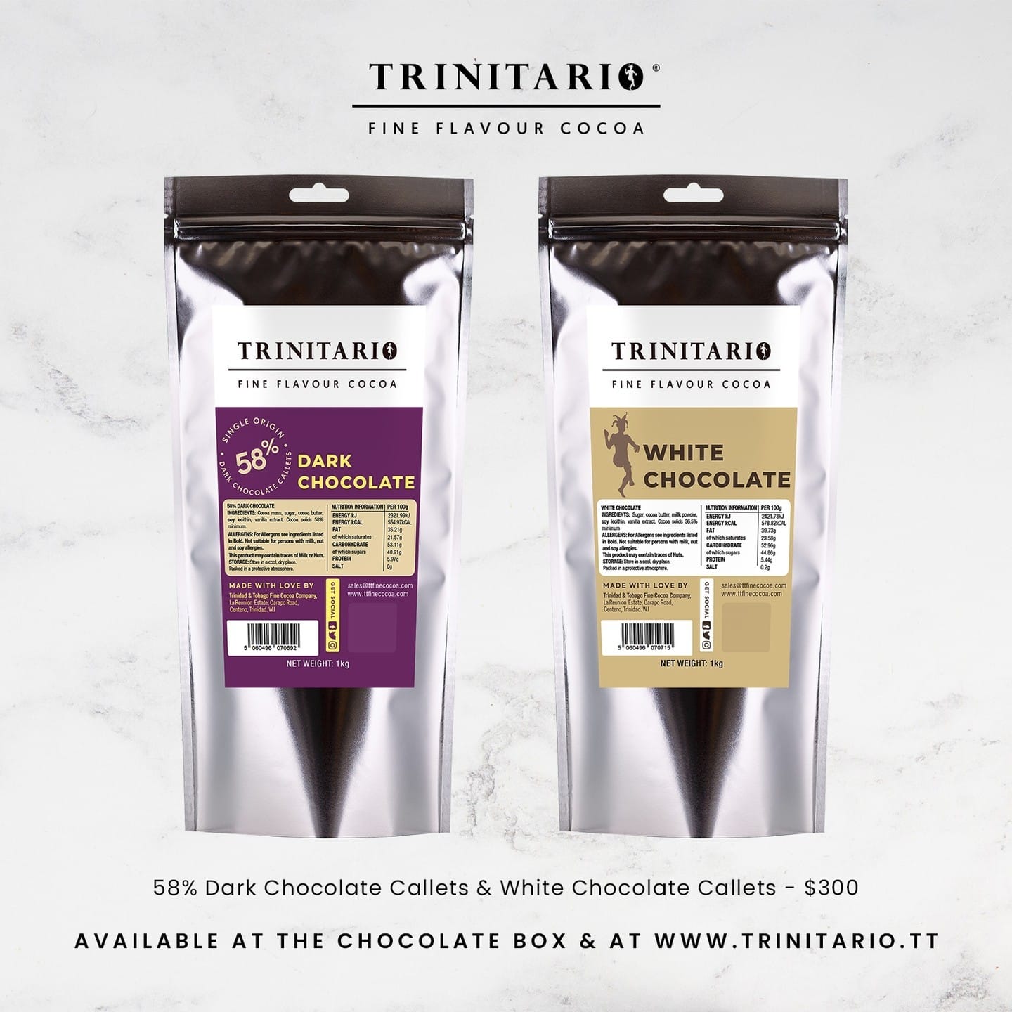 Two silver pouches labelled "Trinitario" contain hand-crafted chocolate callets—58% dark and white—made from single-origin chocolate, displayed side by side on a marble surface. | Trinitario