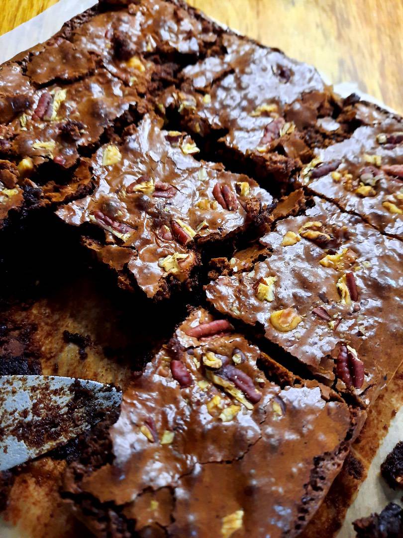 Chocolate brownies topped with chopped nuts